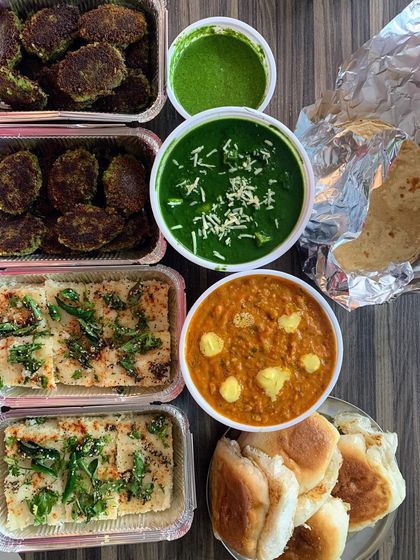 A comforting meal of Palak Paneer, Pav Bhaji, Dhokla, and Hara Bhara Kebabs.