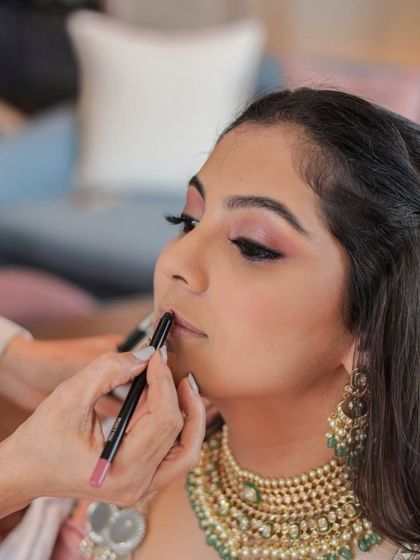 A close-up of the lipstick application. Every step, no matter how small, is done with precision and care to achieve the perfect result.