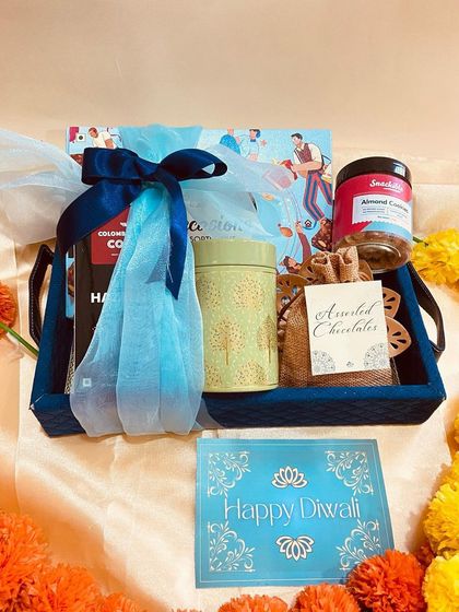 A blue tray hamper filled with coffee and treats, perfect for a cozy Diwali evening.
