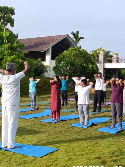 Another angle of our outdoor yoga class, showing the instructor guiding the participants. We ensure personalized attention even in group settings.