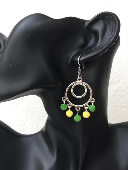 These geometric hoop earrings feature little green and yellow beaded drops for a pop of colour. The colours are fully customisable to match your style.