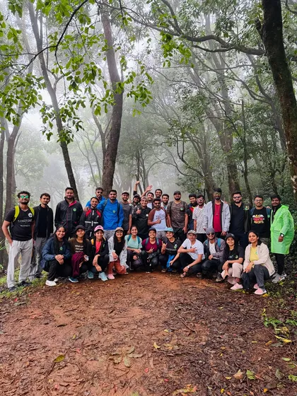 A group photo on the muddy trail, capturing the authentic experience of a monsoon trek in the Western Ghats.