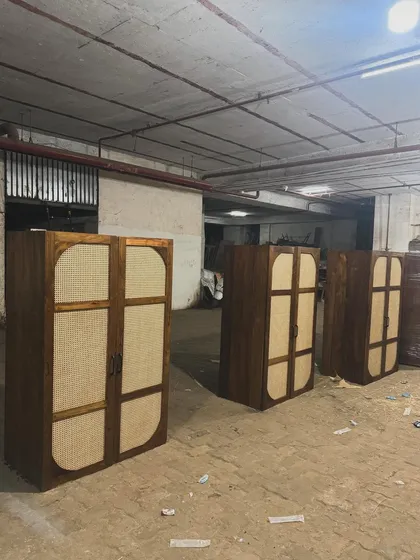 The finished cabinets, featuring a dark wood finish and large cane panels.