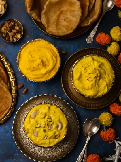 A top-down flatlay of the Shrikhand Puri spread. This composition is perfect for social media, showing all the elements of the festive meal in one beautiful frame.