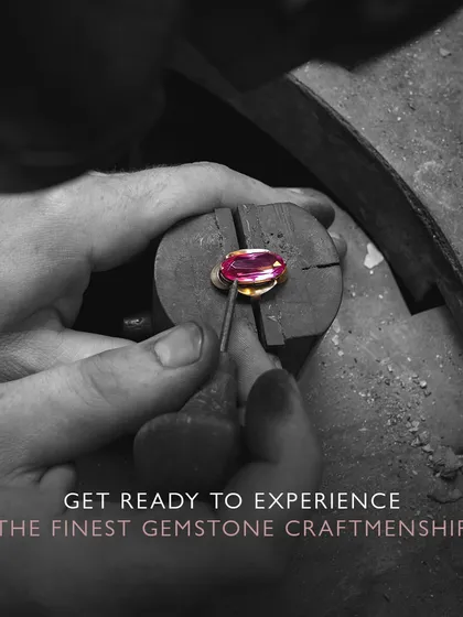 Get ready to experience the finest gemstone craftsmanship. An artisan carefully places a ruby into its setting, a moment where design and material meet to create something beautiful.