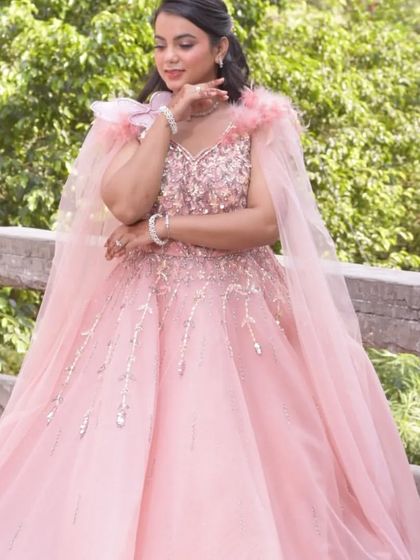 A client posing in the pink gown, showing how it can be styled for a soft and romantic look. It's all about finding the dress that makes you feel special.