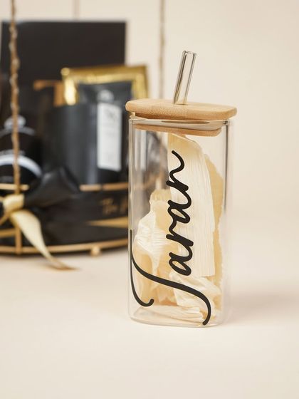 The personalized glass tumbler from the men's birthday hamper, featuring his name in elegant script.