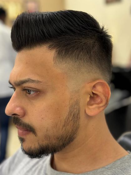 Another angle of a sharp men's haircut, showing the clean lines and expert styling.