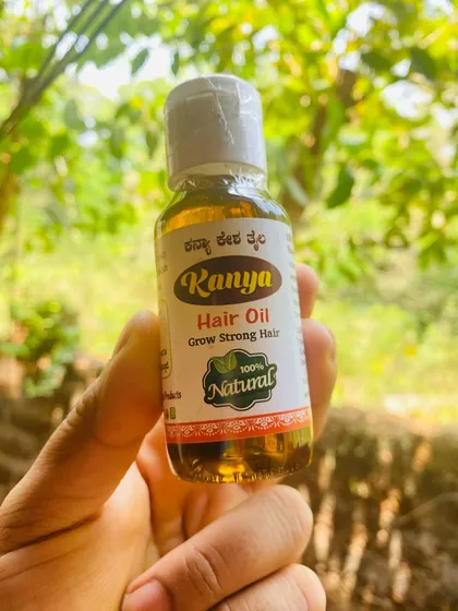 A detailed look at the Kanya Hair Oil bottle. The label lists some of the key benefits, like promoting hair growth and improving scalp health.