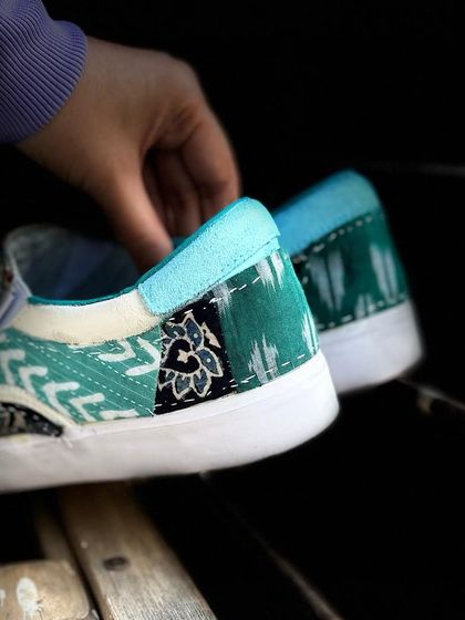 A close-up of the heel of the patchwork slides, showing the different textures and patterns.