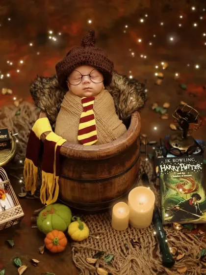 The magic is in the details. This overhead view of our Harry Potter setup captures the full enchanting scene we create for these special newborn sessions.