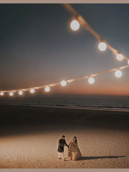 A romantic shot of a couple on the beach at sunset during their Sangeet in Goa. We help plan the event flow to make time for these beautiful moments.