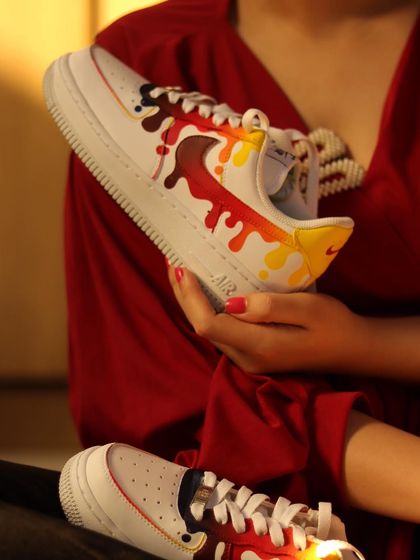 This custom drip design was inspired by the old Instagram logo colors. The warm red, orange, and yellow tones create a fiery and eye-catching effect on the white AF1s.