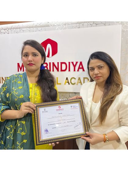 We celebrate the diversity of our students. This graduate proudly holds her certificate, ready to make her mark in the beauty world.