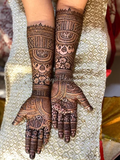 A complete engagement mehendi for a happy bride. The design is intricate and covers the full arms, creating a stunning look for her special day.
