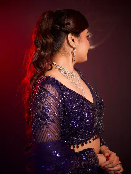 A closer look at the deep purple sequin lehenga's blouse. The sheer sleeves with sequin work add a touch of modern elegance.