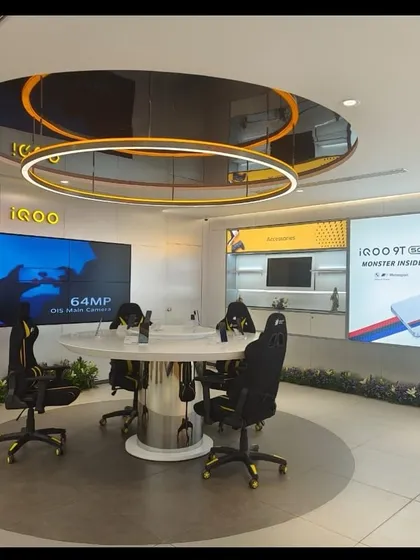The futuristic iQOO gaming and experience zone within a retail showroom. This space required integrating advanced technology, custom lighting, and branded elements into a cohesive and interactive environment.