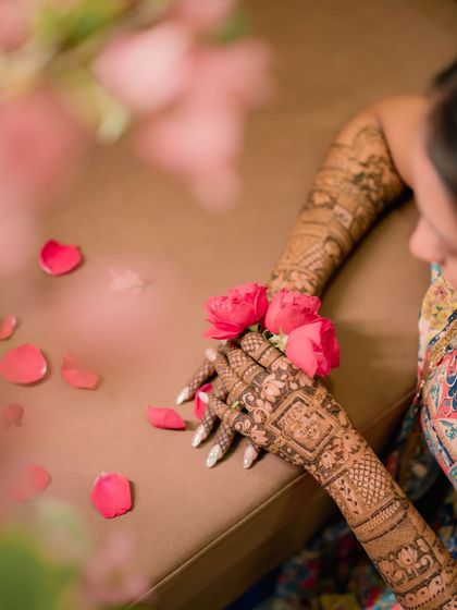A quiet moment of reflection for the bride, her hands beautifully decorated and ready for the days ahead.