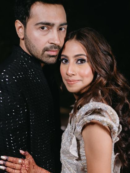 An intimate close-up of the couple, highlighting the bride's flawless makeup.