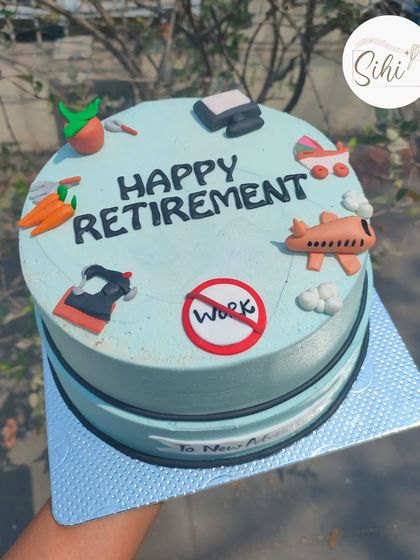 A sweet cake to celebrate a happy retirement. The design features fondant toppers representing new hobbies like gardening and travel, with a "No Work" sign.