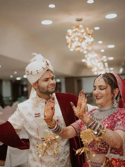 The couple makes a grand, dance-filled entrance to their wedding event, surrounded by clapping guests. Pure energy and happiness.