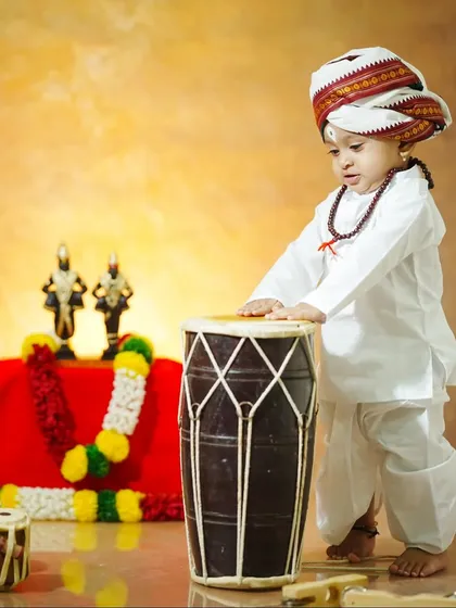 A candid moment as the little boy curiously touches the pakhawaj drum.