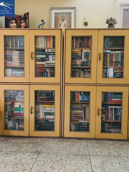 The full view of our guide's personal library cabinets. This is the collection that fuels the conversations and recommendations at our Reading Retreat.