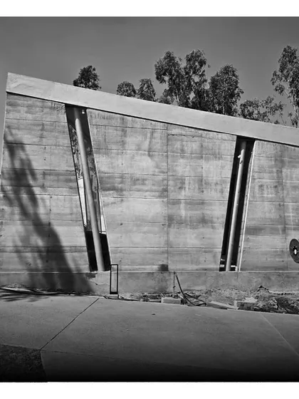 A retreat in the making. The angular, rammed-earth walls of a resort cottage stand in stark contrast to the surrounding greenery.
