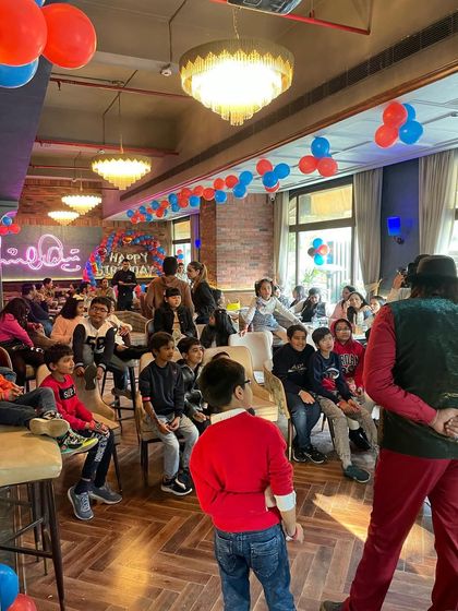 A wide shot of my magic show in progress. You can see the kids are completely captivated by the performance, giving parents a chance to relax and enjoy.