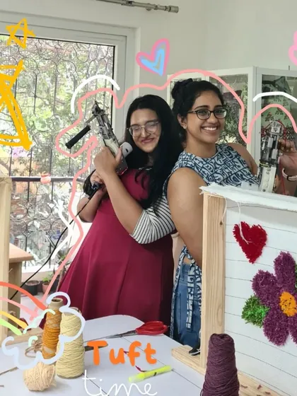 Tuft time with your bestie is the best time! These two friends are all smiles, posing with their tufting guns before diving into creating their floral and heart-themed rugs.
