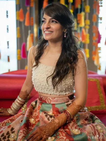 A candid portrait of a bride, smiling happily during one of her pre-wedding events. Her natural joy is what makes this photo beautiful.