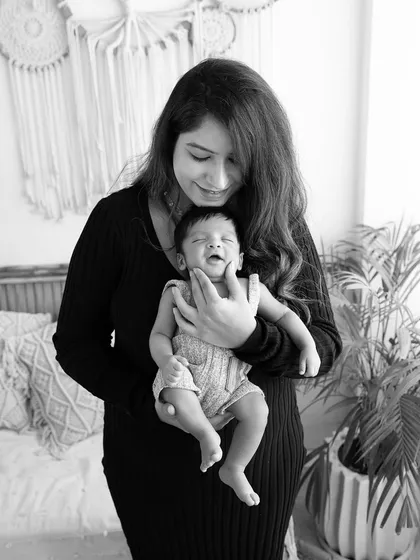 A mother's gentle touch. This black and white image captures a mother soothing her baby, a simple, beautiful moment of connection.