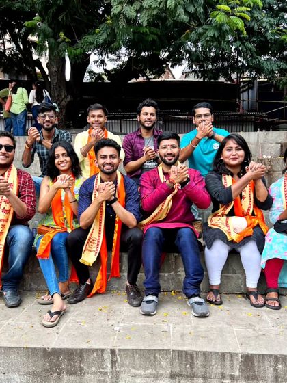 A duplicate of the group wearing traditional scarves during the Ganesh festival celebrations in Pune.