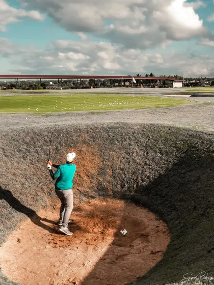 A player takes on one of our challenging pot bunkers. These deep bunkers are designed to help golfers prepare for the toughest courses.