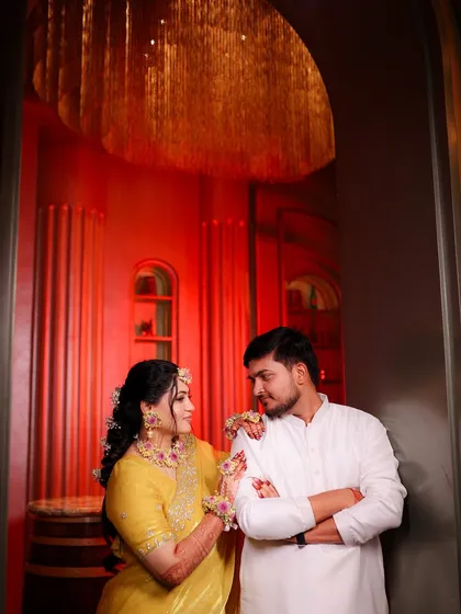 A dramatic and beautifully lit couple portrait from the haldi function.