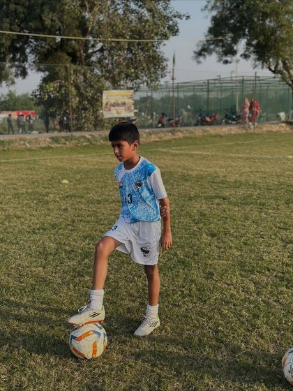 One of our youngest academy members, poised and ready with his football. We nurture passion for the game at every age.