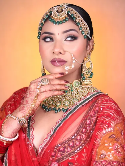 Another angle of the green bridal look, showcasing the intricate matha patti and nose ring, and how the makeup complements these traditional accessories.