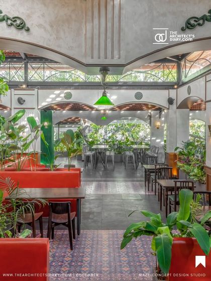 Another perspective of the dining space at Adda 1522, showing how the red benches and greenery create a lively contrast. The design encourages social gatherings in a relaxed, nostalgic setting.