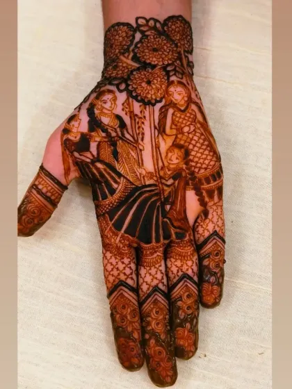 A perfect example of a Teej festival mehandi. The main design shows women celebrating on a jhula, surrounded by intricate patterns on the fingers. These theme-based designs are a wonderful way to get into the festive spirit.