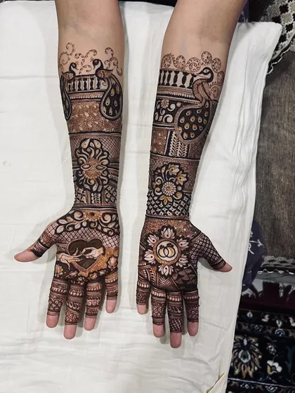 A unique design with a heart-shaped frame for a hand-holding motif on one palm and wedding rings on the other.
