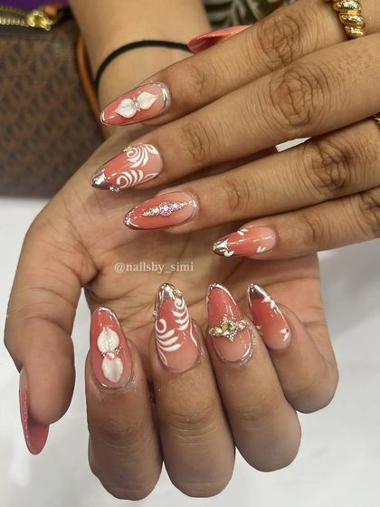 My first attempt at a bridal chic competition! This intricate design features delicate white swirls and 3D elements over a peachy base, perfect for a bride who wants unique, artistic nails.