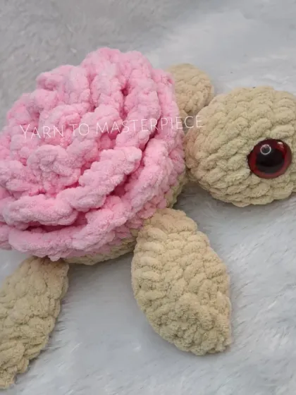 A close-up of a single plush rose turtle, highlighting the detailed rose petal shell.