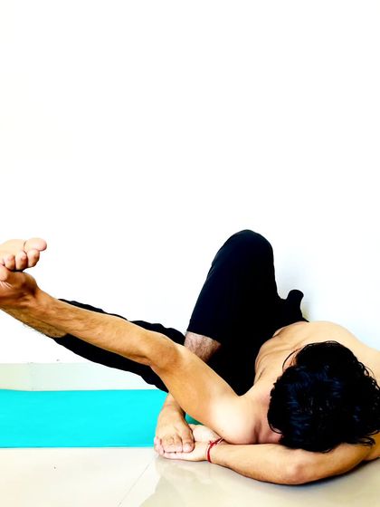 An advanced twisting and balancing pose that requires deep hip opening and spinal flexibility.