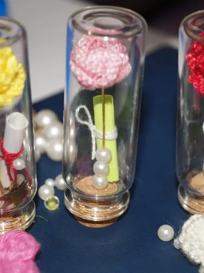 A closer look at the details inside my 'message in a bottle' gifts, featuring tiny roses, pearls, and a heartfelt, rolled-up note.