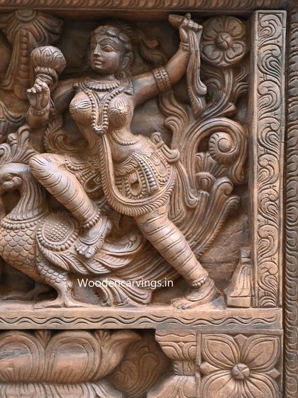 Another perspective on the Apsara panel, this time showing a figure dancing with a parrot. The depth of the relief work creates a dynamic sense of movement and interaction between the figures.