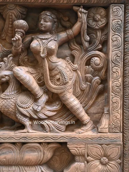 This detail from the Apsara panel shows a celestial dancer with a peacock. The intricate carving of the feathers and the graceful posture of the figure highlight the romantic and artistic theme of the piece.