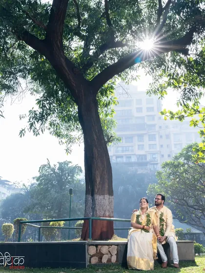 Finding a quiet spot for a portrait can create a wonderful sense of peace. We placed this couple under a large tree, using the sun flare to add a touch of magic to this serene moment on their wedding day.