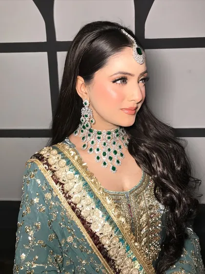A side profile, showing the beautiful waves in her hair and her statement earrings.