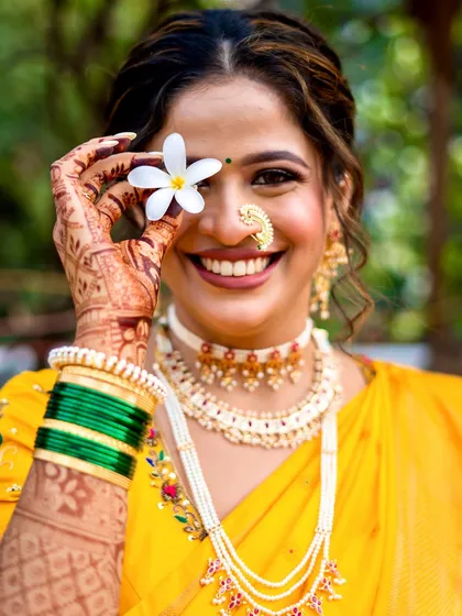 A playful and happy portrait. The makeup is fresh and light, perfect for a daytime wedding ceremony, ensuring the bride feels comfortable and beautiful.