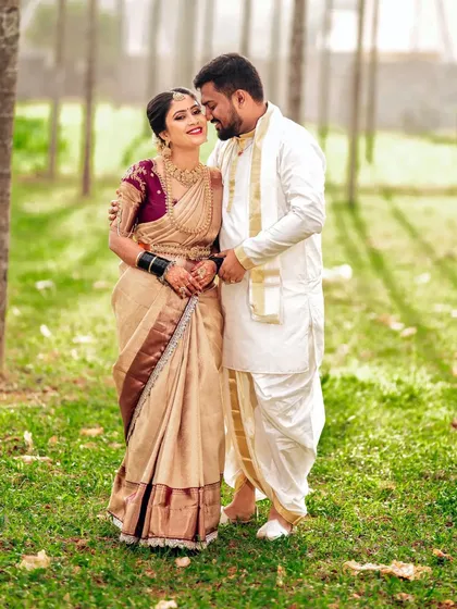 An intimate portrait of the couple in a garden setting, their traditional outfits complementing the natural beauty around them.